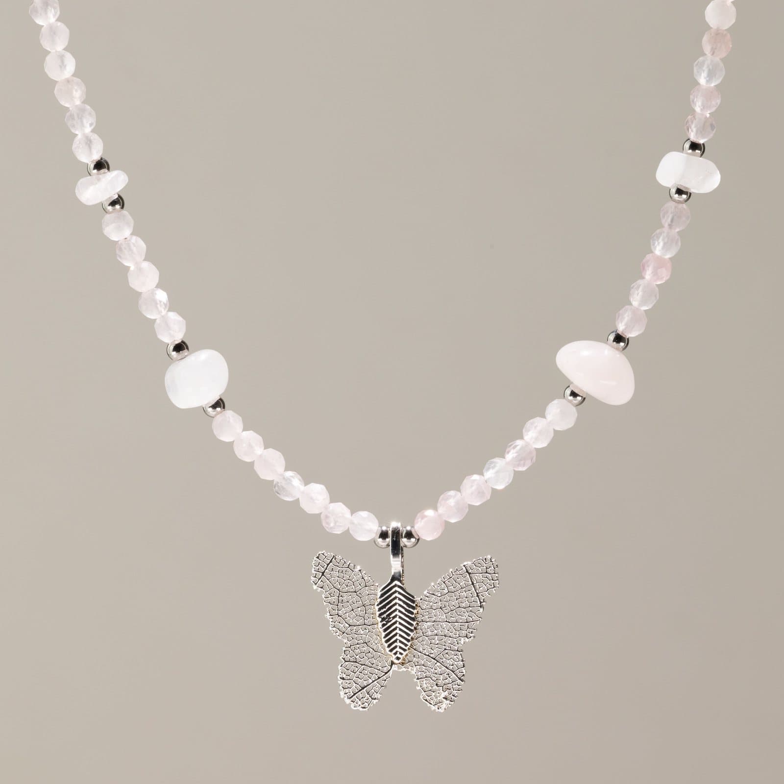Pink faceted rose quartz bead necklace with a silver-plated leaf butterfly pendant