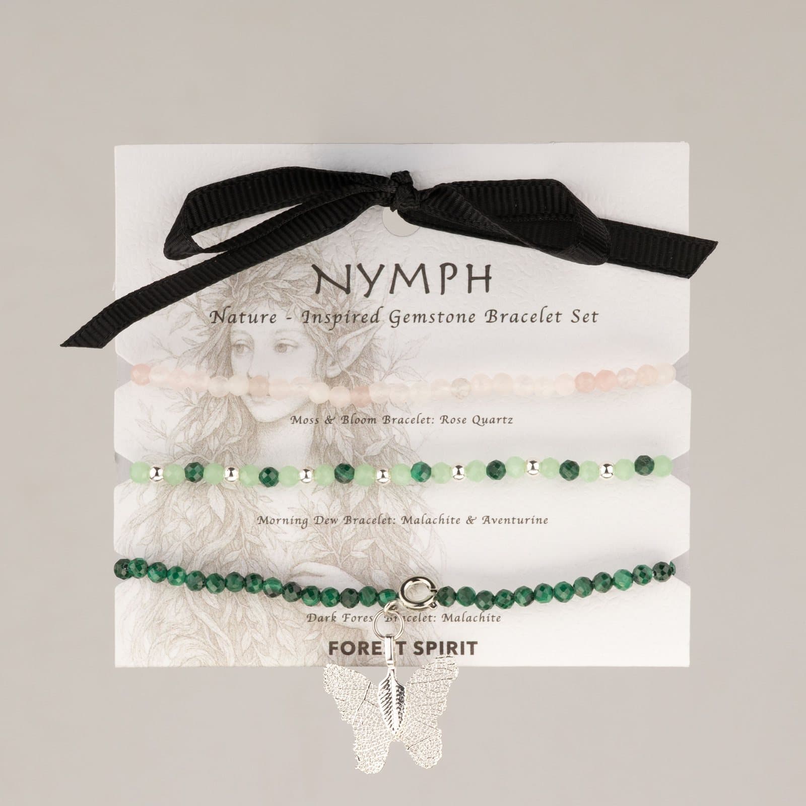Three gemstone bracelets in pink and green on an illustrated card