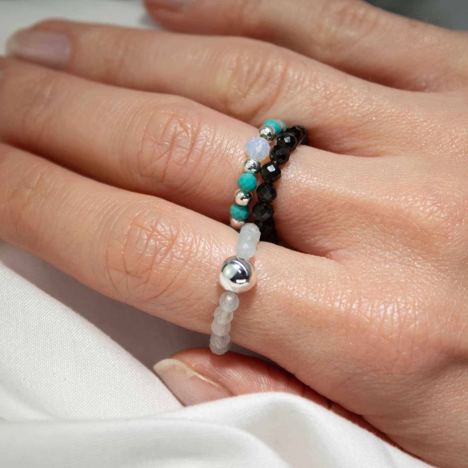 Set of three elasticated gemstone rings with silver-tone beads