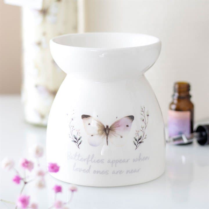 White ceramic oil burner with a soft grey butterfly design and a message