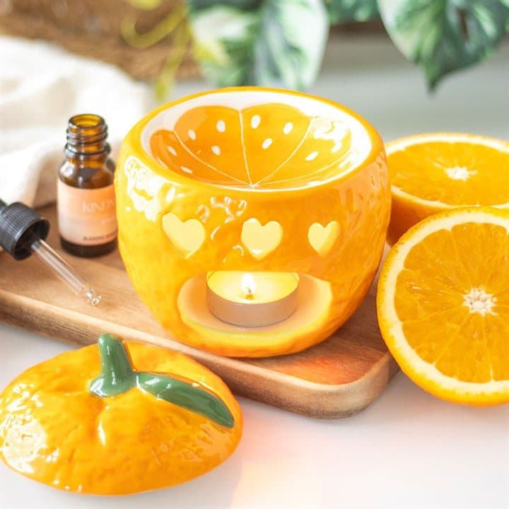 Ceramic oil burner shaped like a freshly picked orange