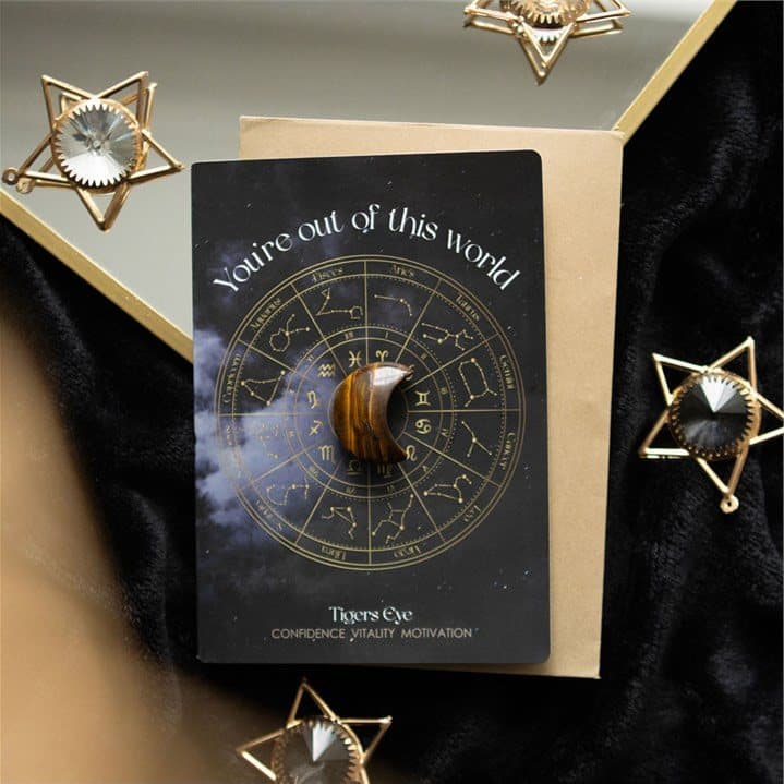 Greeting card with an astrology wheel design and a tiger's eye crescent moon crystal