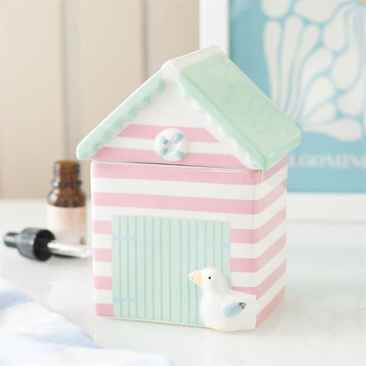 Pastel ceramic oil burner shaped like a beach hut with a removable lid