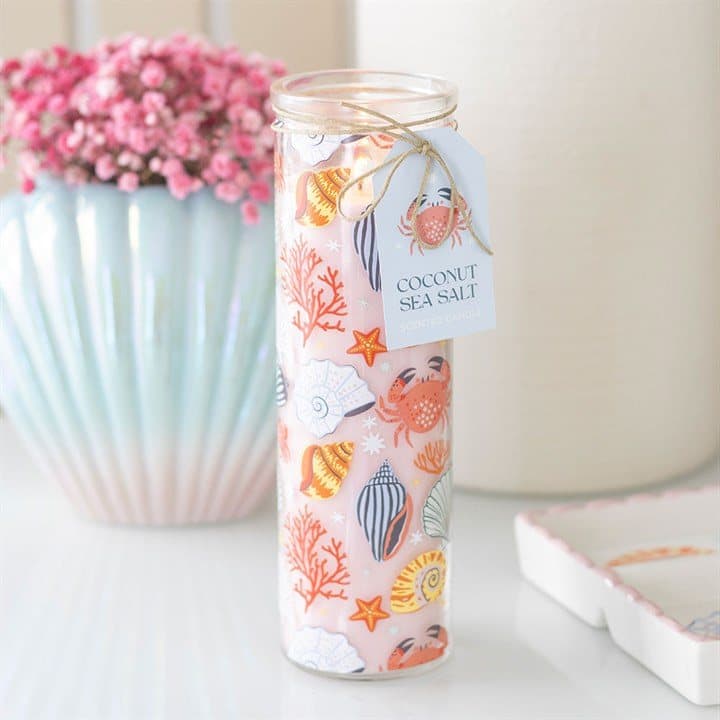 Tall glass candle with crabs, seashells and starfish in soft pastel tones