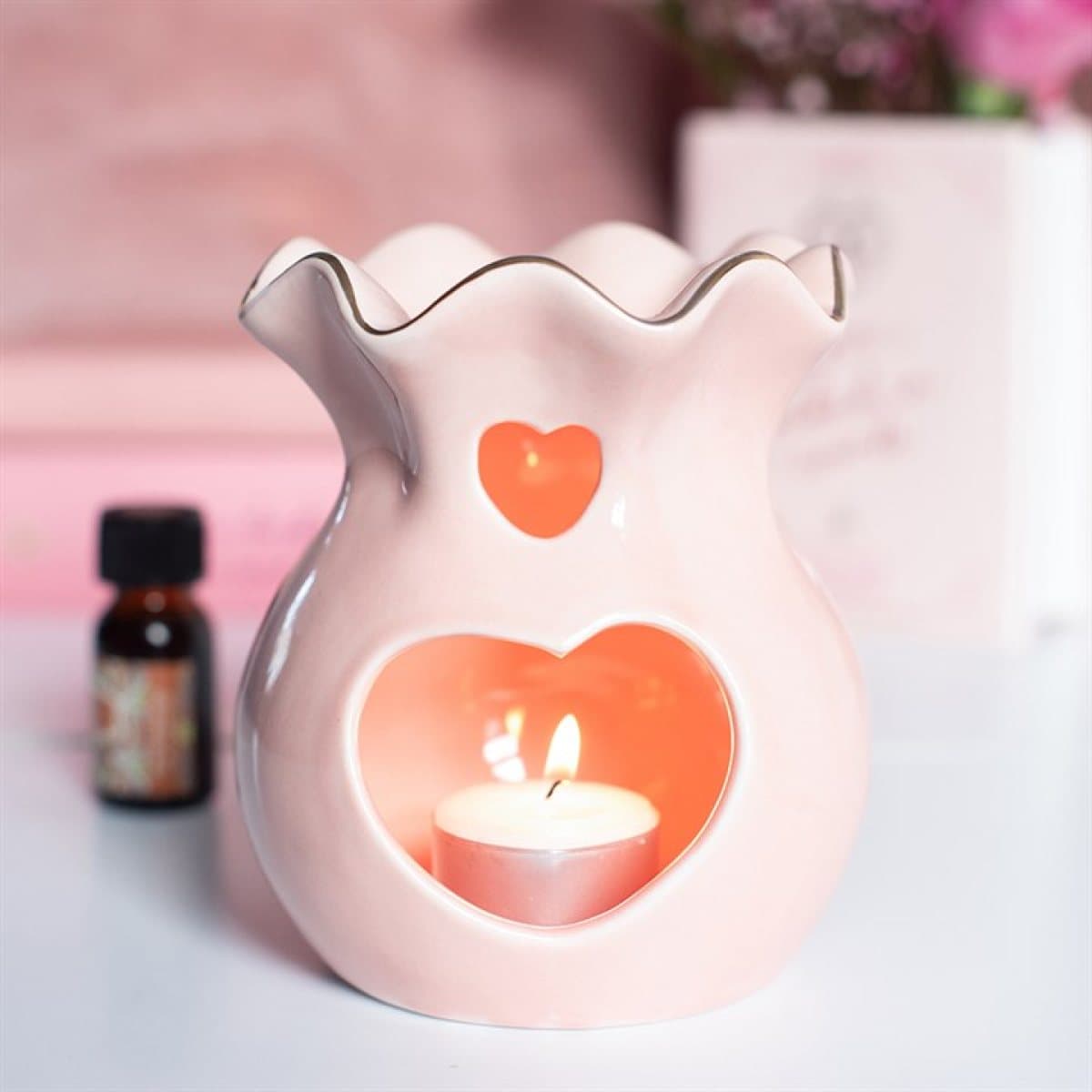 Pink fluted ceramic oil burner and wax warmer with a heart detail
