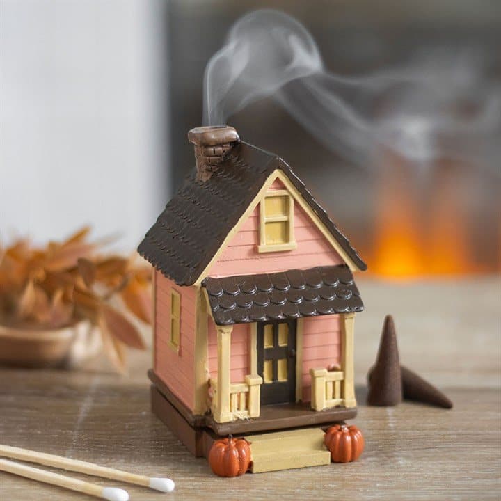 Pink resin house incense cone burner with pumpkin details and a chimney