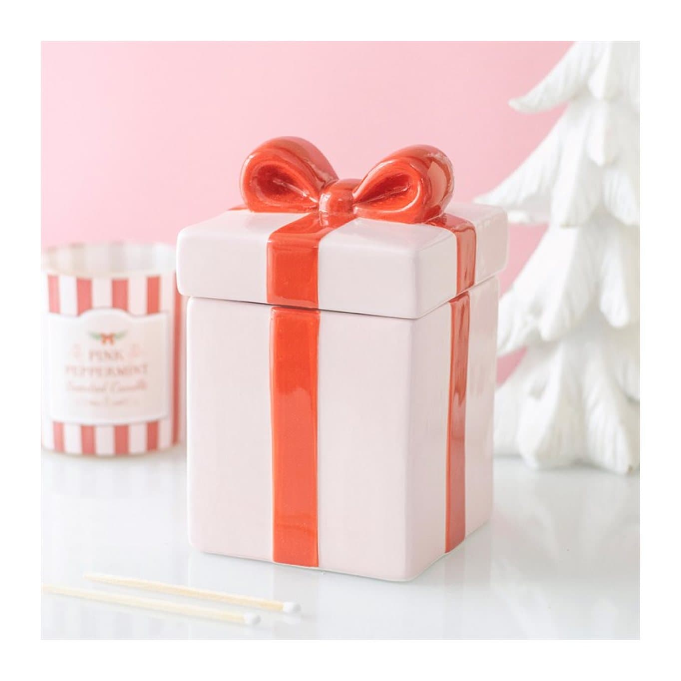 Pink present-shaped ceramic oil burner with a red ribbon design