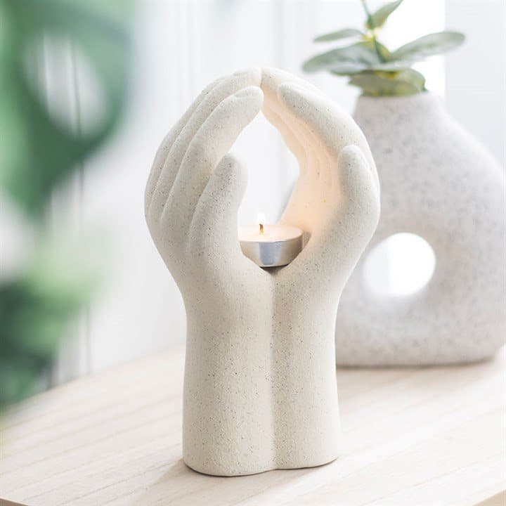 Ceramic tealight holder shaped like a pair of hands in prayer