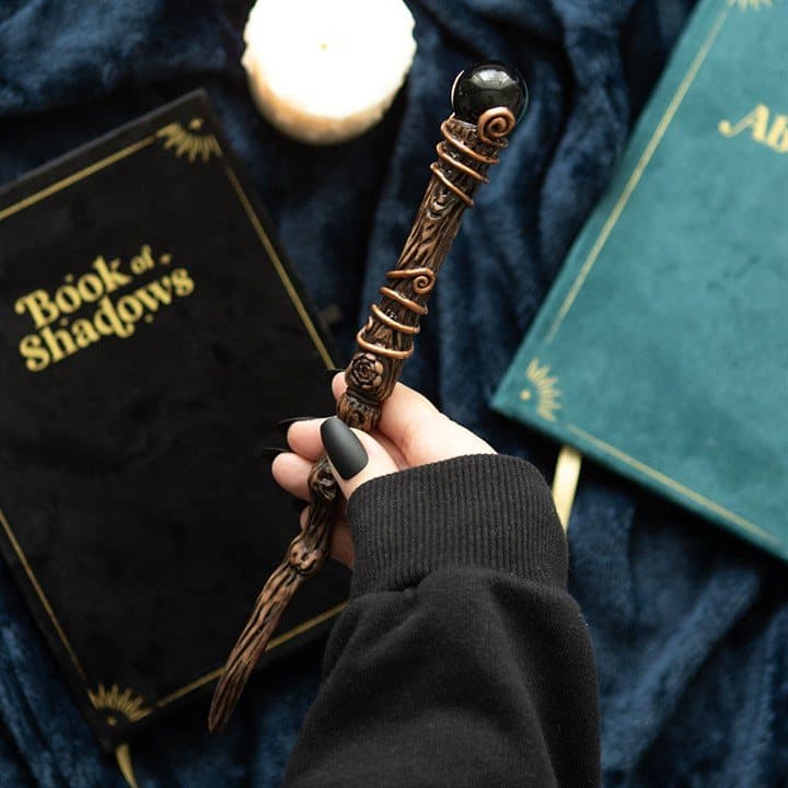 Black obsidian crystal wand with its storage pouch