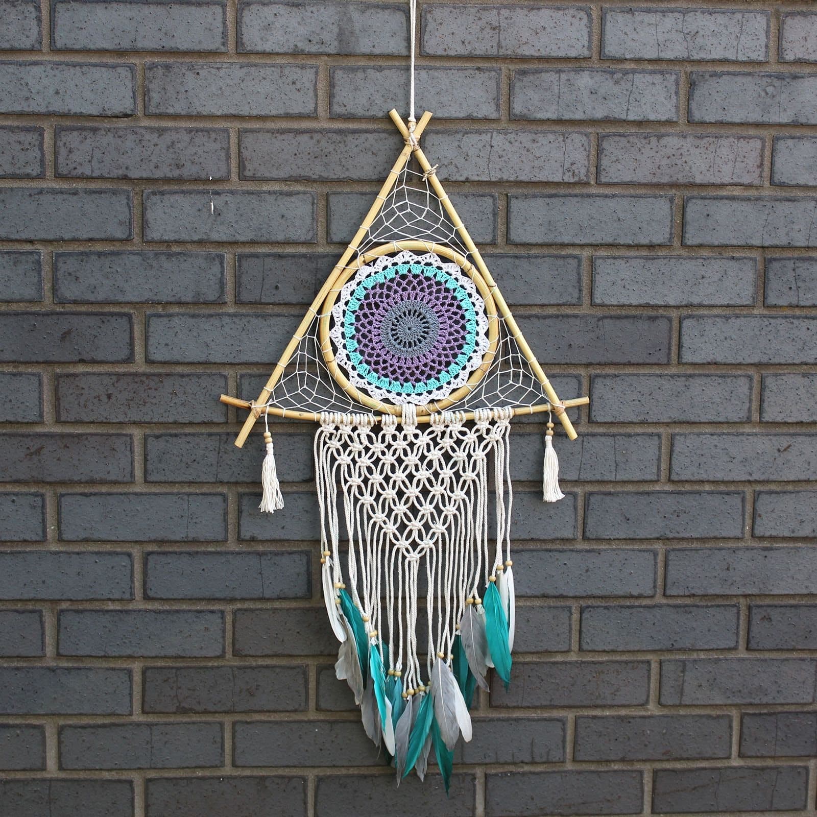 White and turquoise macrame pyramid dream catcher with feathers