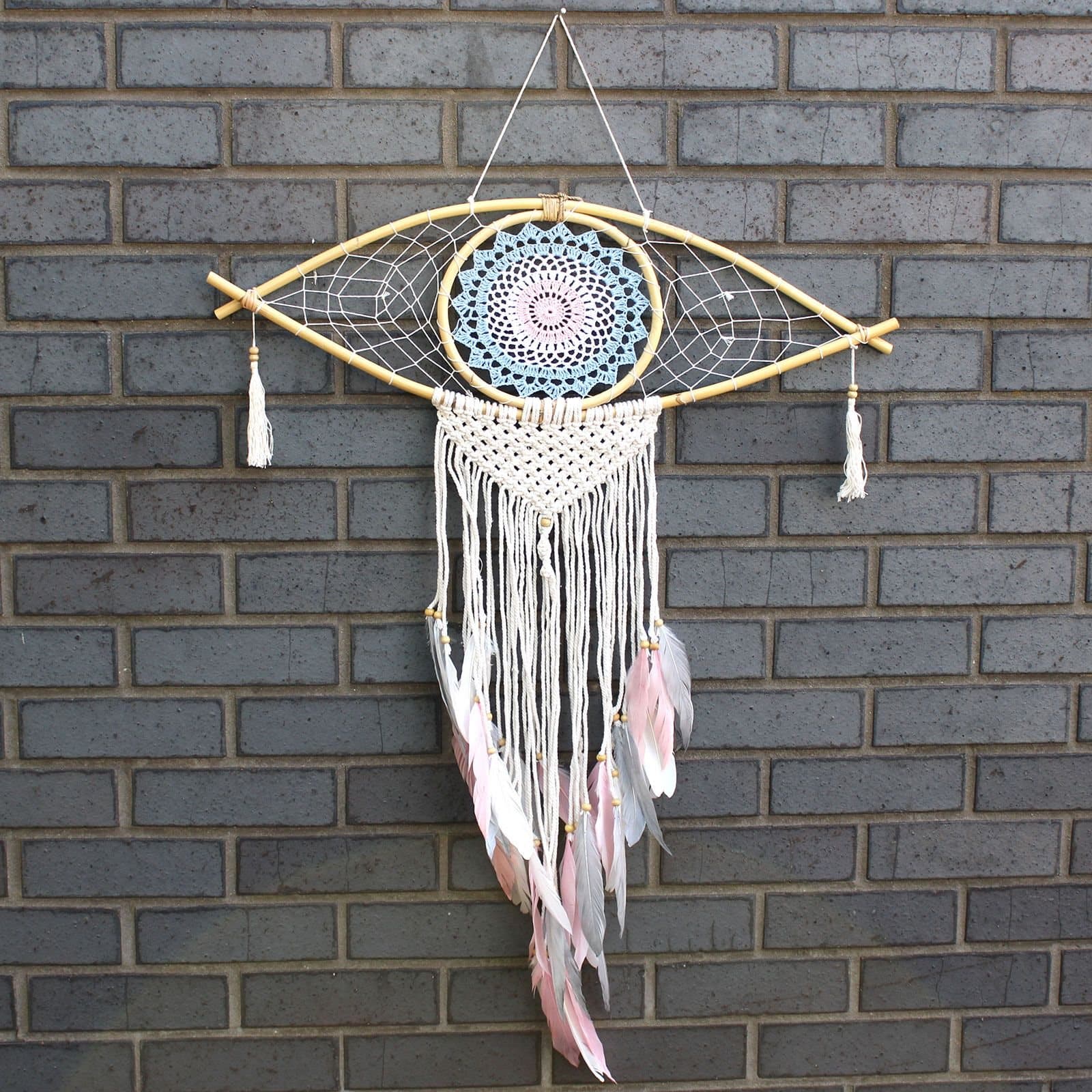 Large macrame dream catcher with an evil eye, rattan frame and feathers