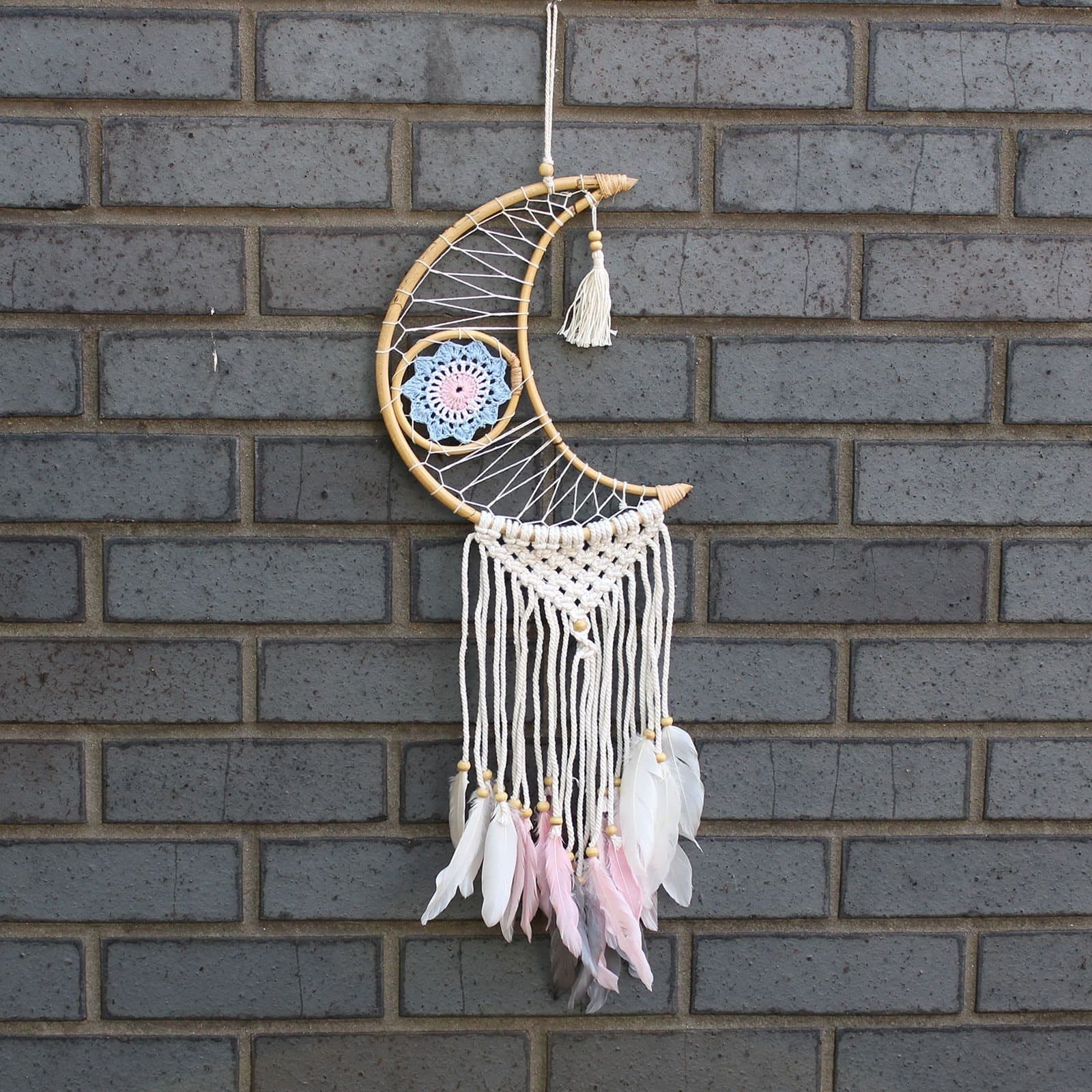 Handmade rattan dreamcatcher with macrame details, evil eye and feathers