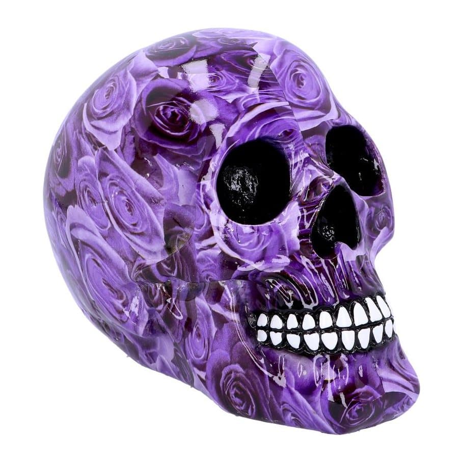 Resin skull ornament covered in purple roses with a white grin