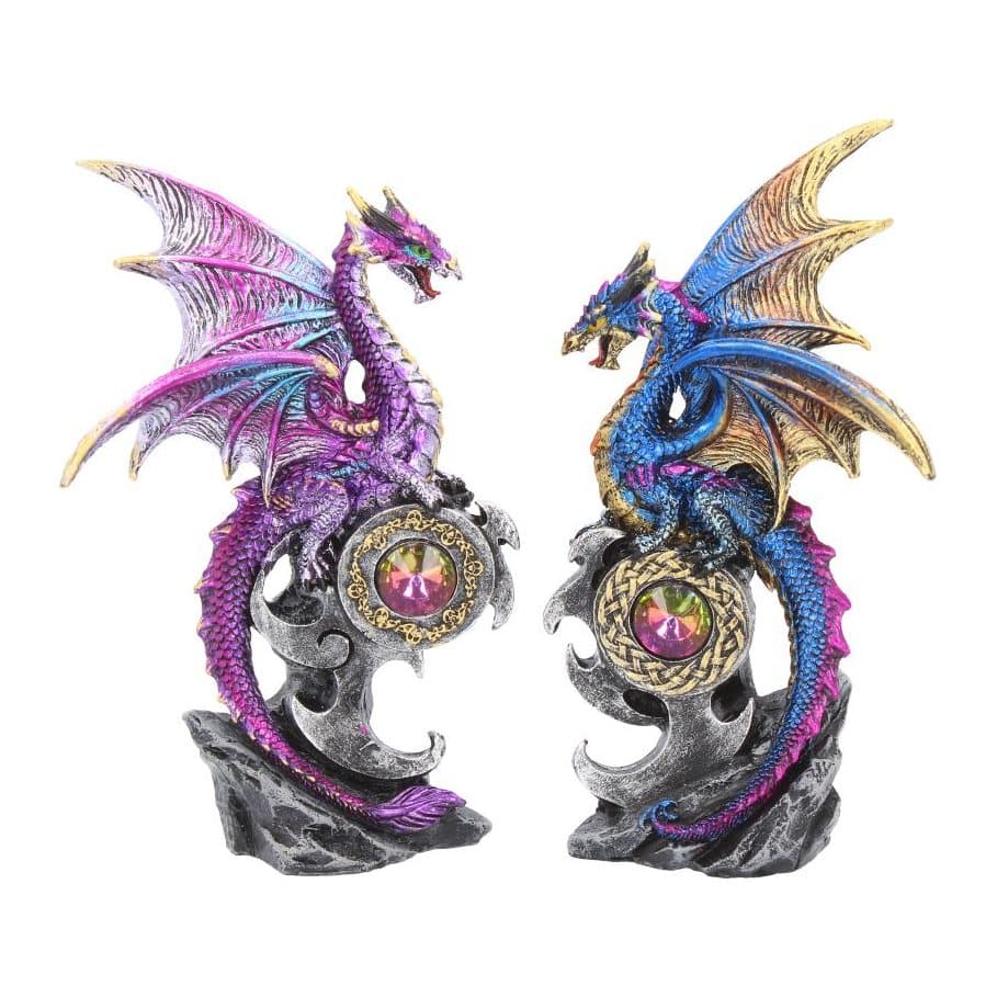 Two blue and purple dragon figurines with spread wings on jewelled perches