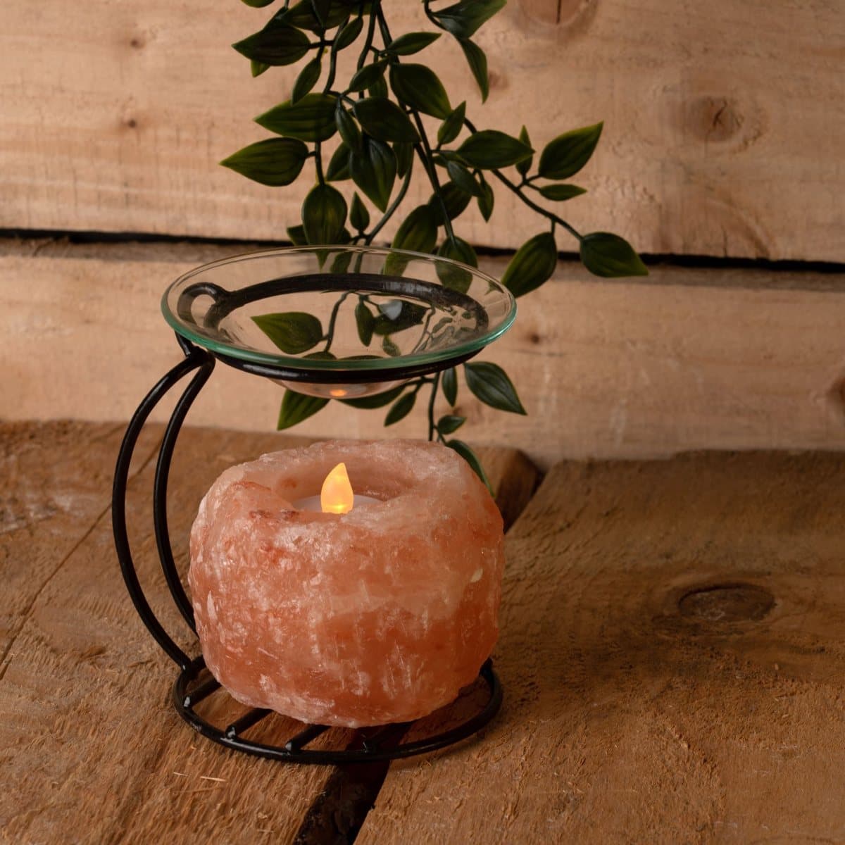 Himalayan rock salt oil burner on a metal stand