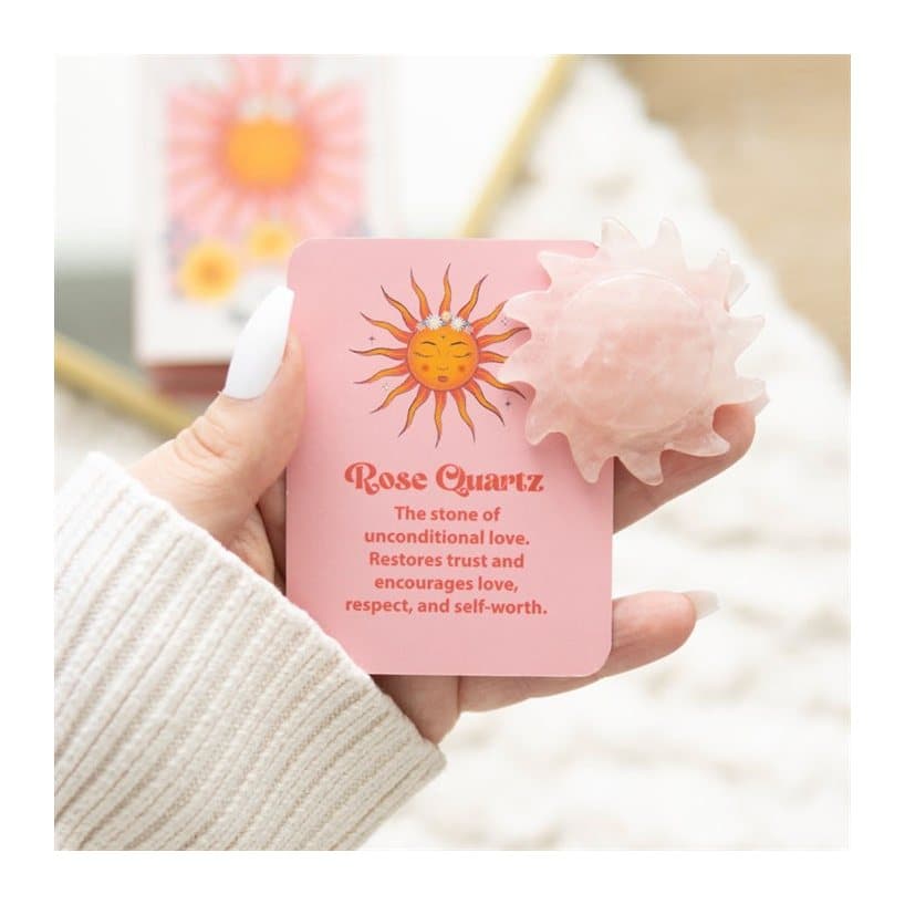 Pink rose quartz stone carved as a sun, with its colour cardboard box