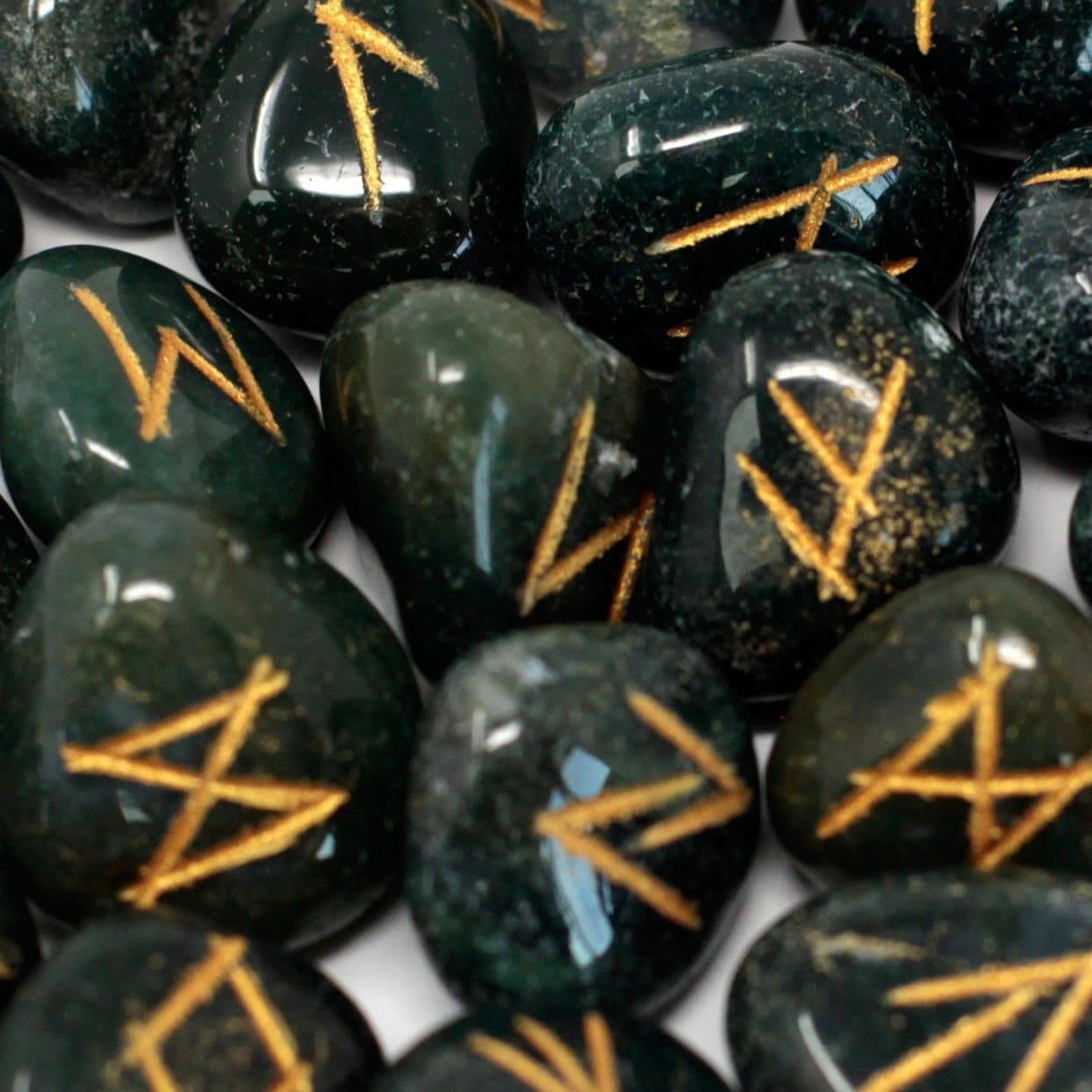 Bloodstone rune stones with rune symbols beside a pouch
