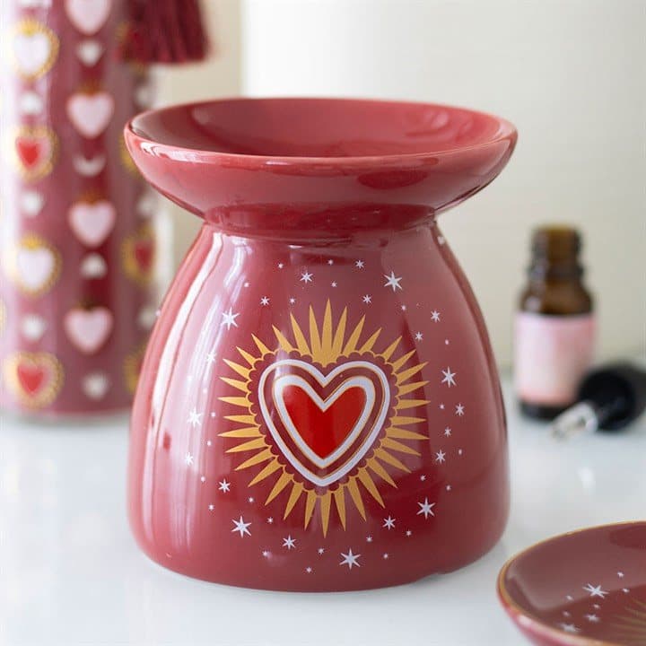 Ceramic oil burner with a radiant sacred heart design