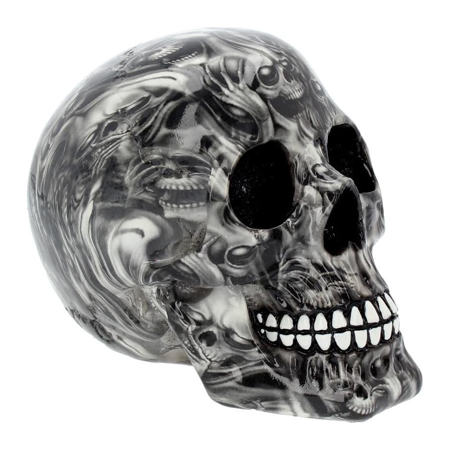 Black grinning resin skull ornament covered in ghostly screaming skulls