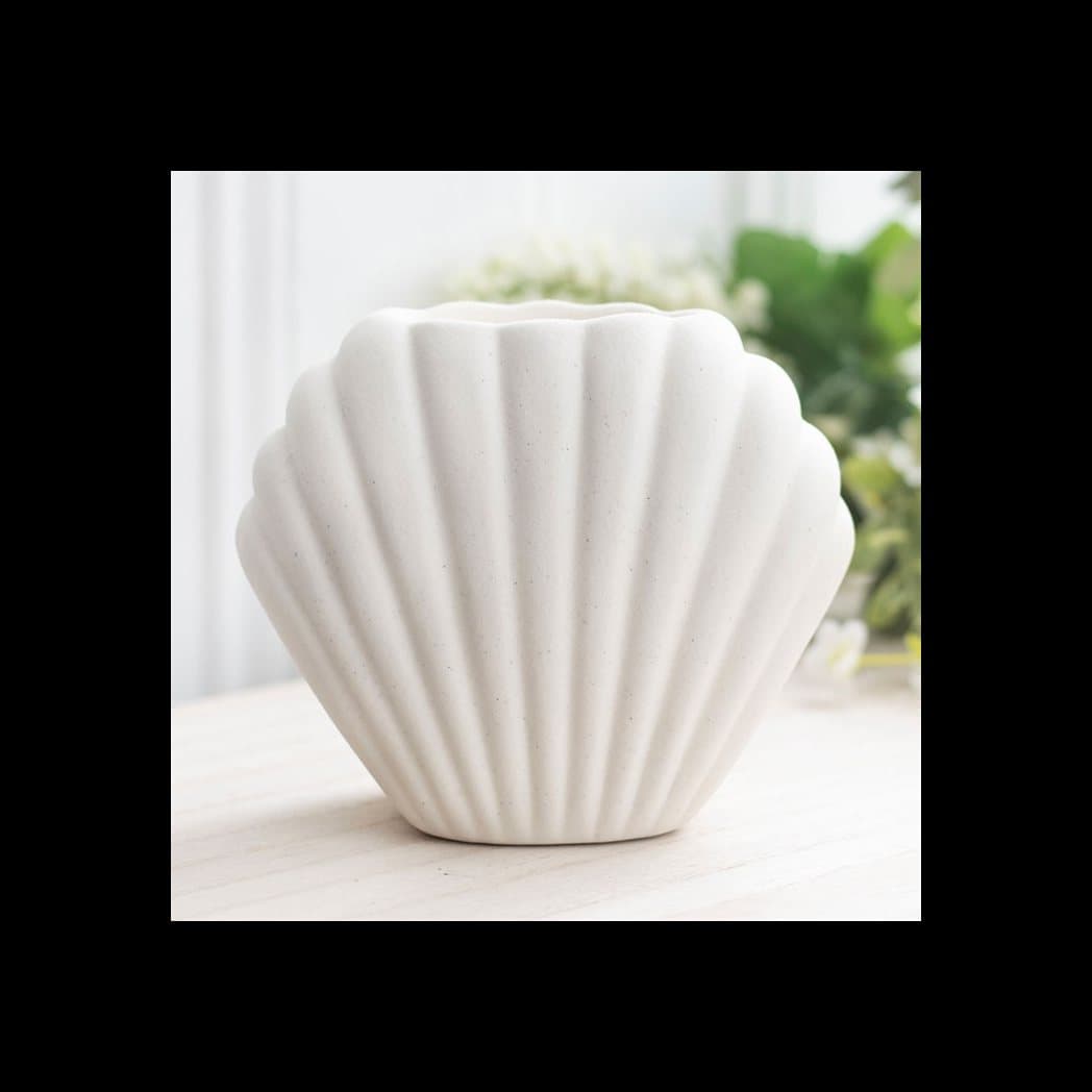 Neutral stone coloured ceramic seashell oil burner
