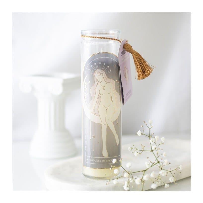 Tube candle in a glass jar decorated with amethyst crystals