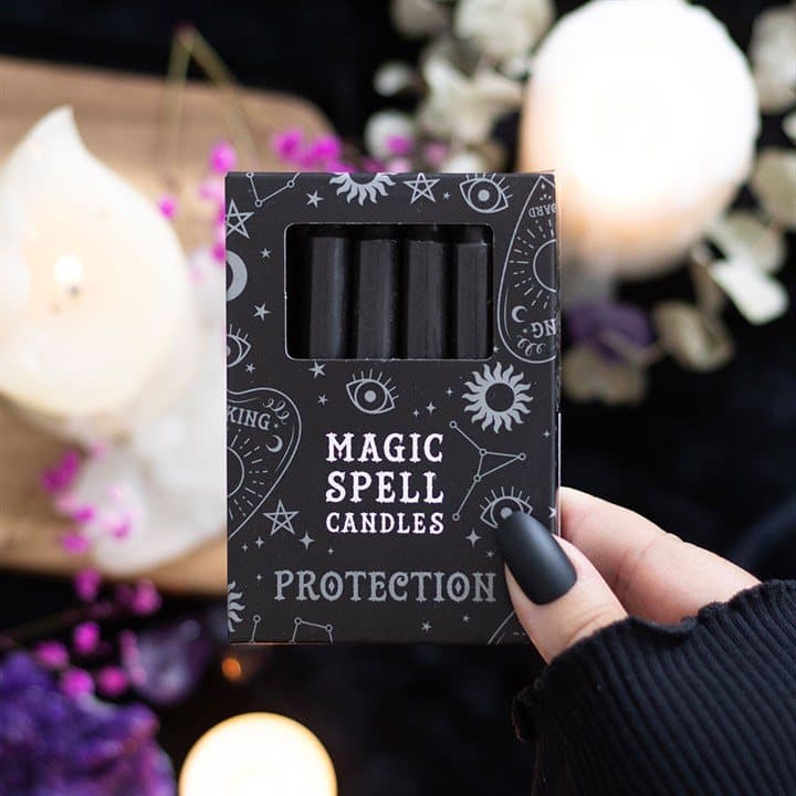 Pack of 12 black spell candles in a picture box with a window