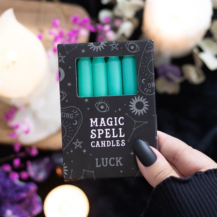 Pack of 12 green spell candles in a picture box with a window