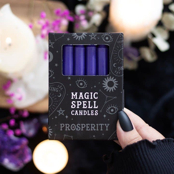 Pack of 12 purple prosperity spell candles in a picture box with window