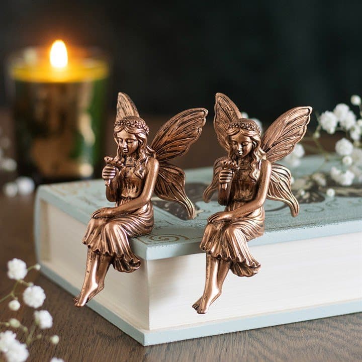 Two antique bronze effect resin fairy shelf sitters with wings and dresses