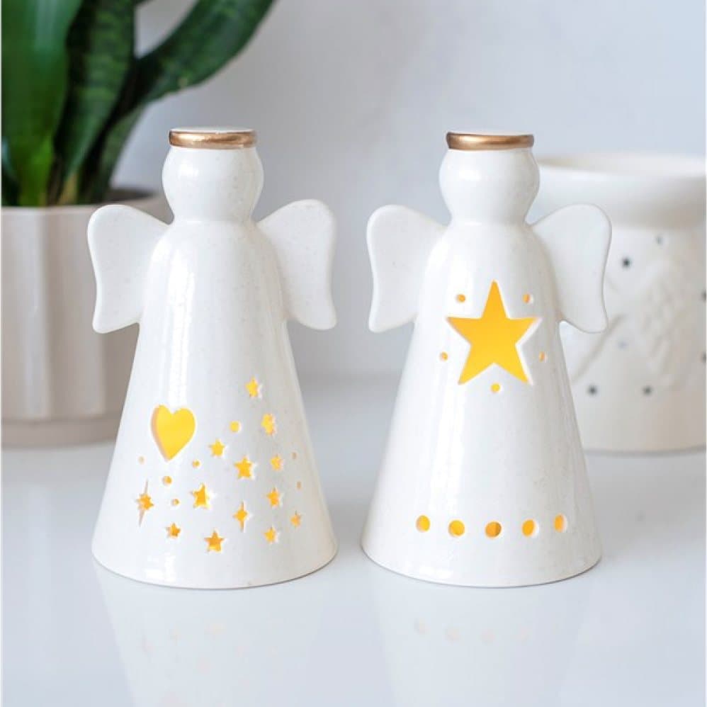 Pair of off-white ceramic angels with heart and star cut-outs and gold details