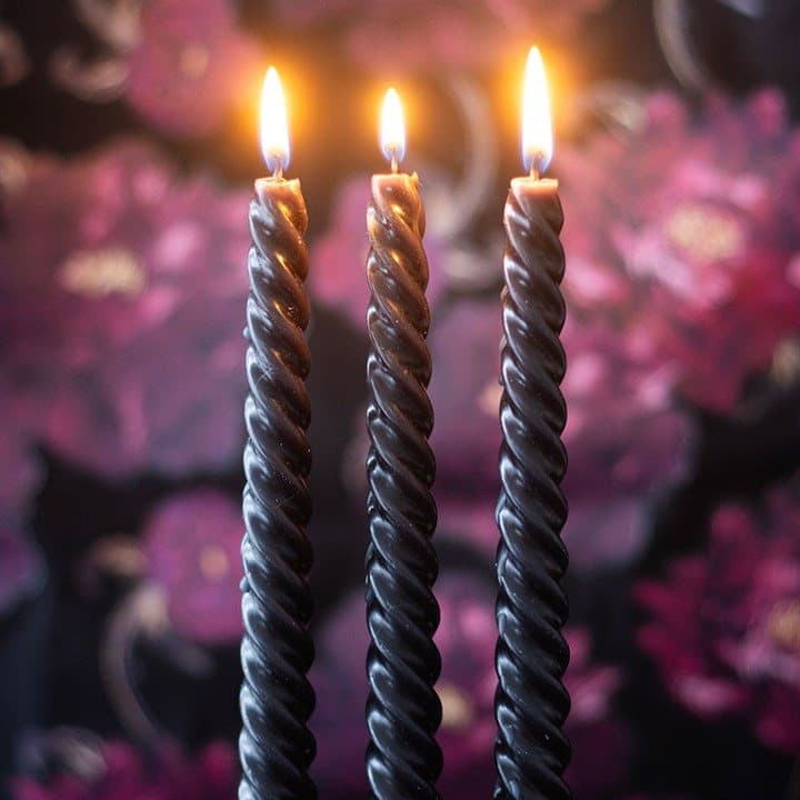 Three black twist taper candles in a window box