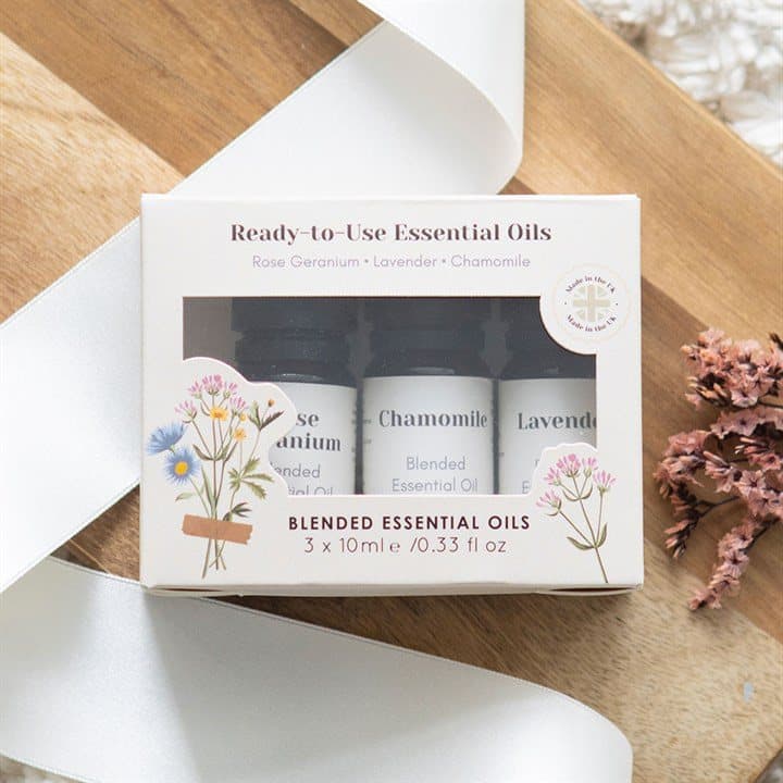 Three 10 ml glass essential oil bottles in a colour cardboard box with a window