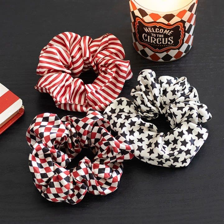 Set of three circus print hair scrunchies on a cardboard back