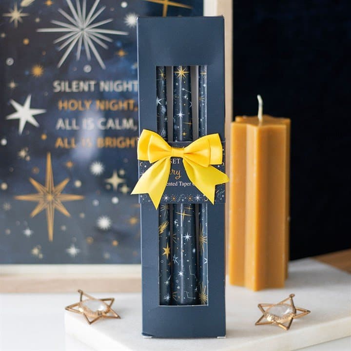 Three taper candles with a starry night design
