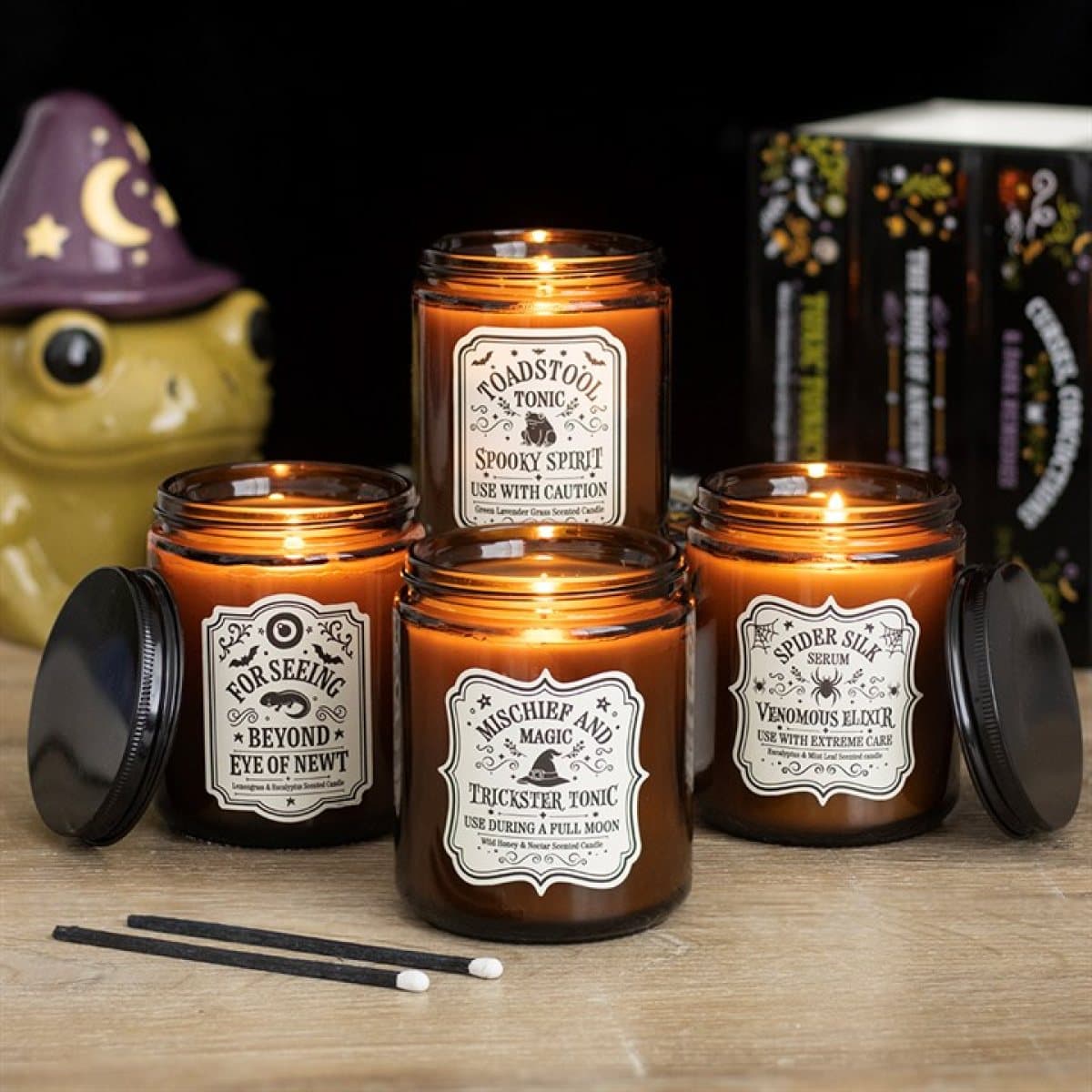 Set of four amber jar candles with potion-inspired labels