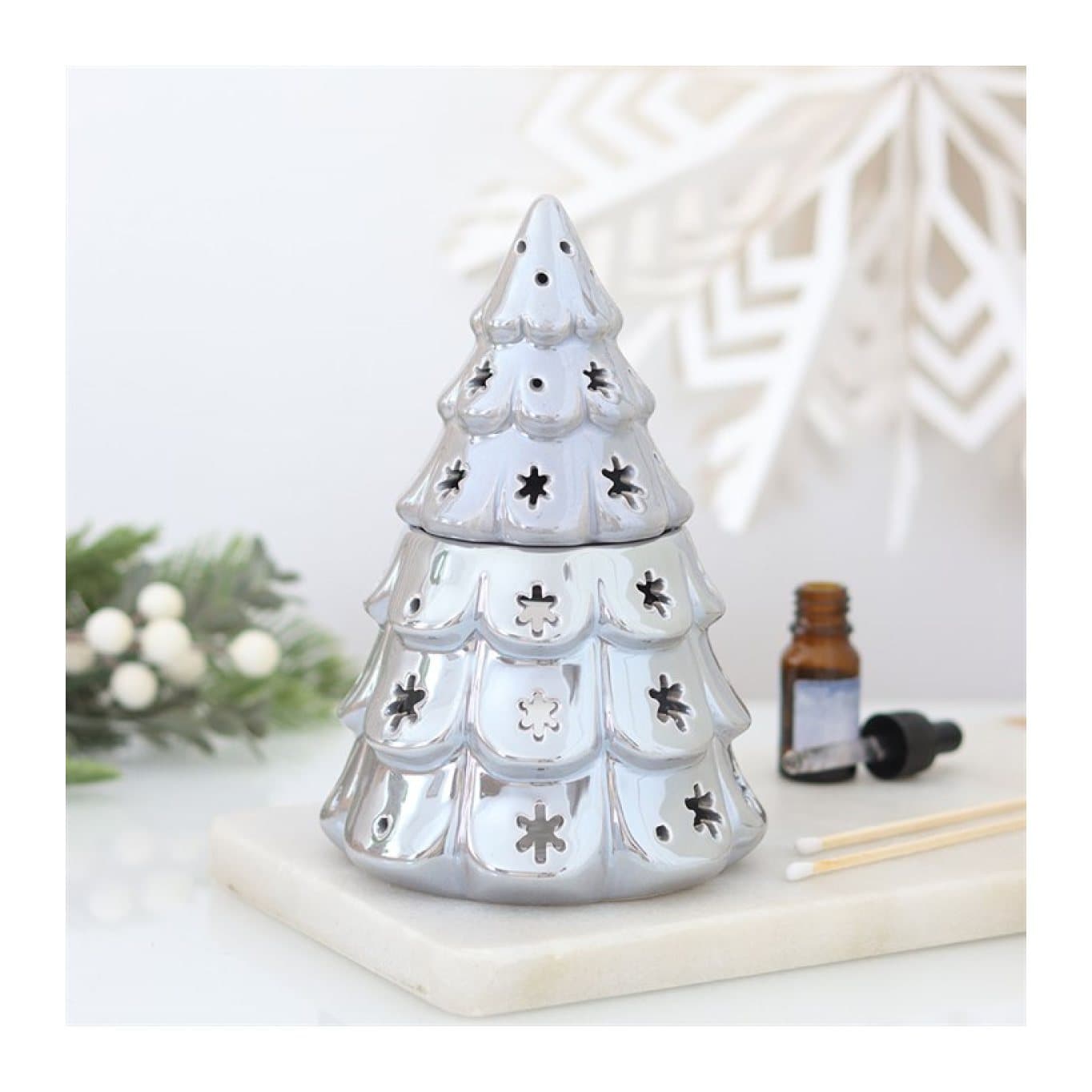 Silver ceramic fir tree oil burner with cut-out snowflakes