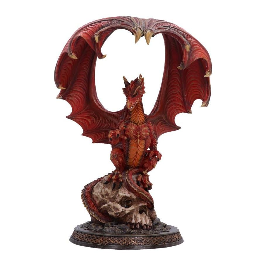 Red dragon figurine perched on a skull with wings raised