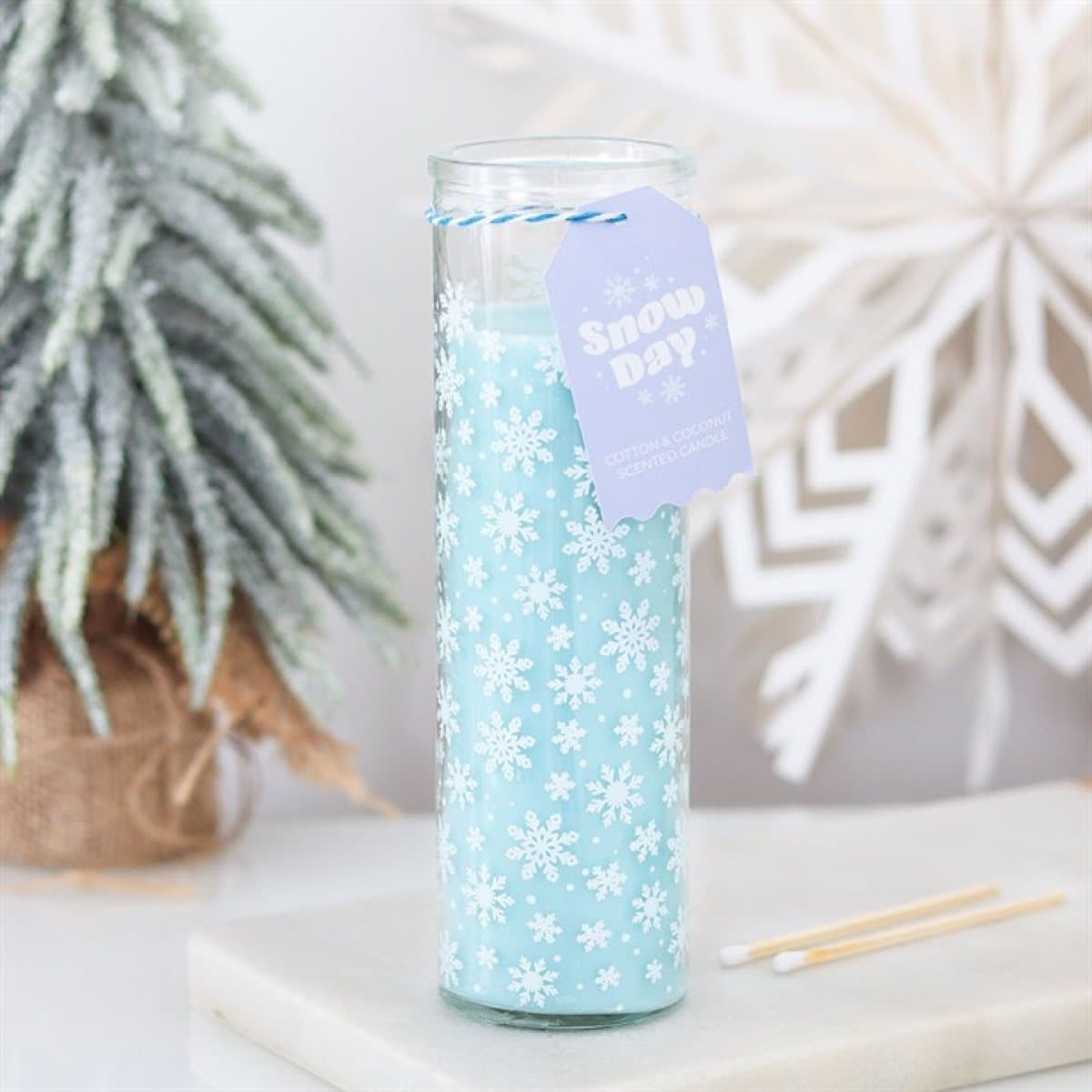 Glass tube candle decorated with snowflakes, with a hang tag