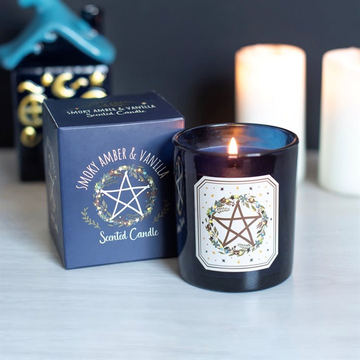 Scented candle in an illustrated vessel with a botanical pentagram design