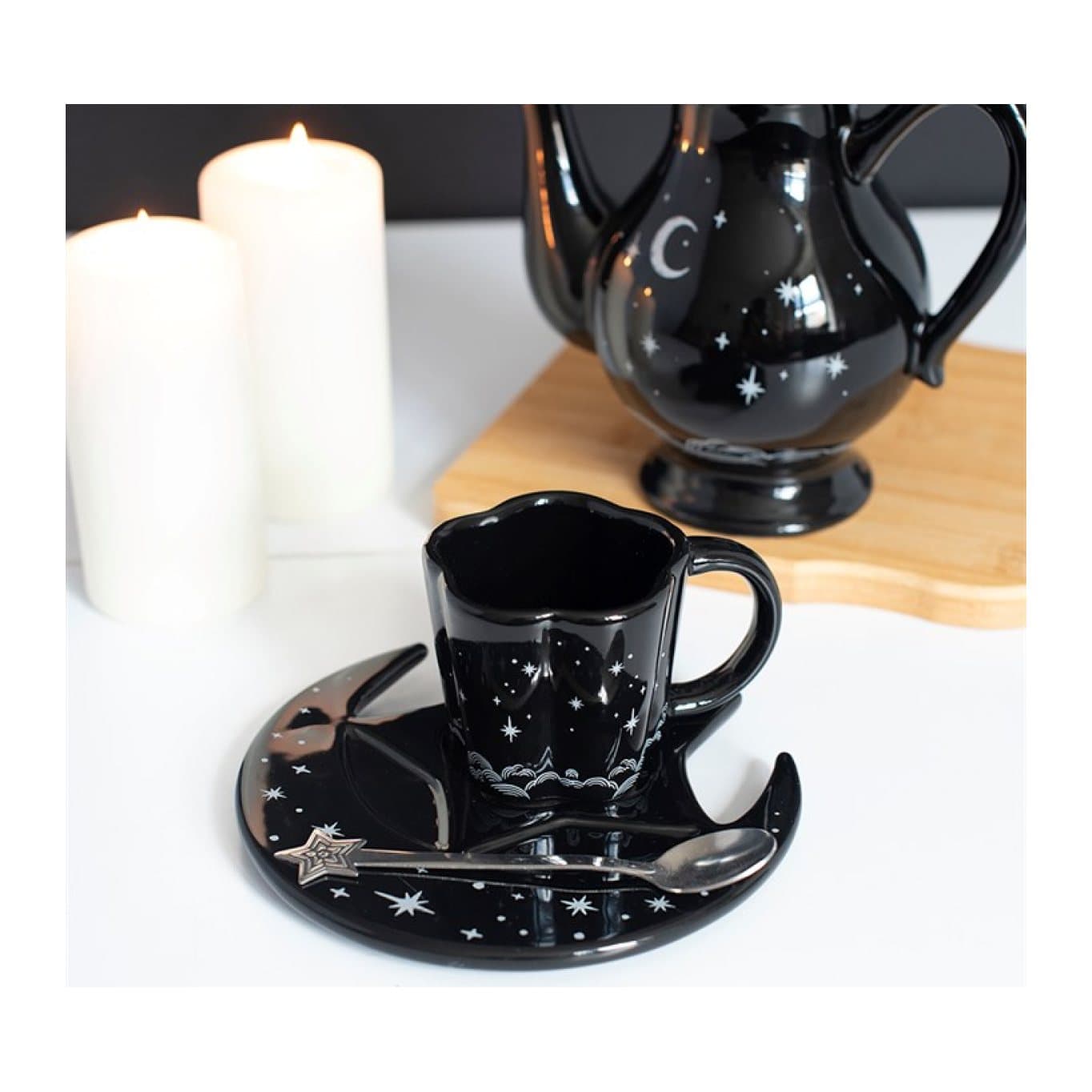 Black espresso cup with moon-shaped saucer and star-topped metal spoon