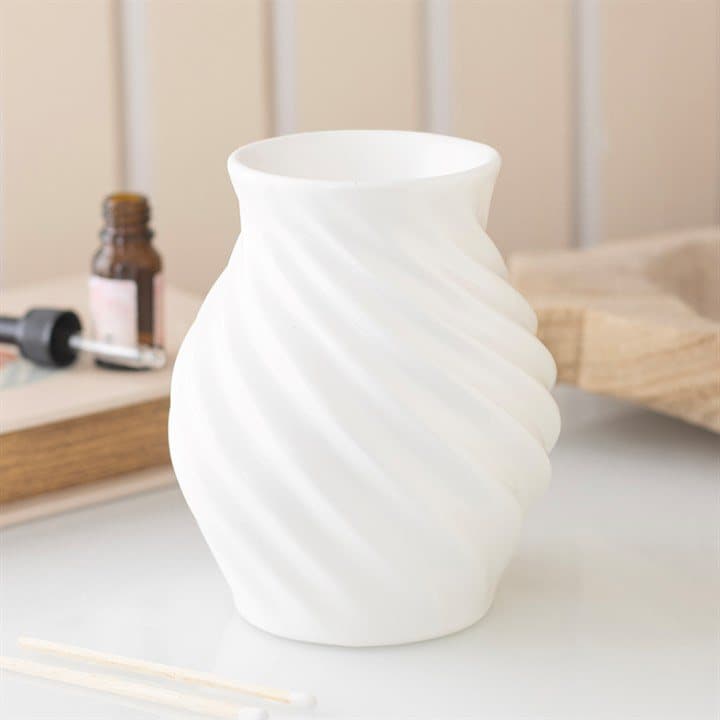 Ceramic oil burner and wax warmer with a spiral swirl design