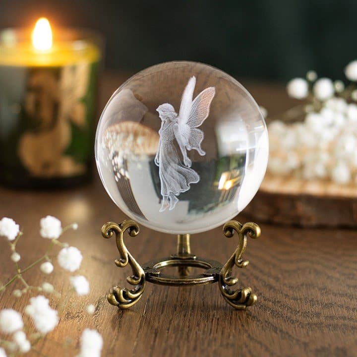Glass crystal ball engraved with a fairy on an ornate antique-style stand