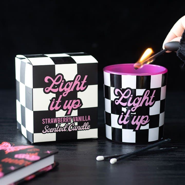 Checkerboard candle with Light It Up text in a colour cardboard box