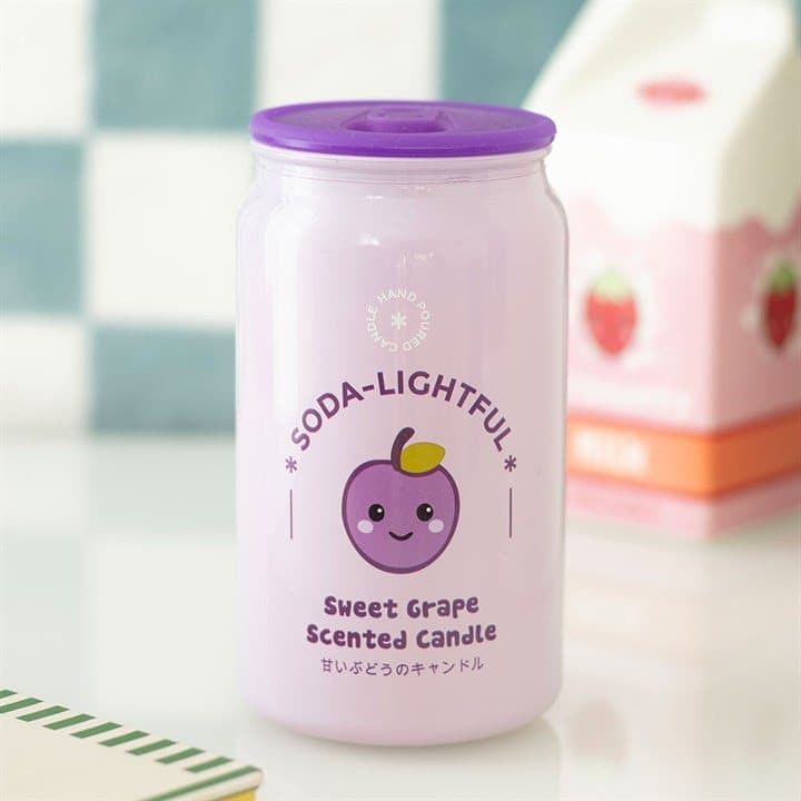 Purple soda can shaped candle with a kawaii grape design