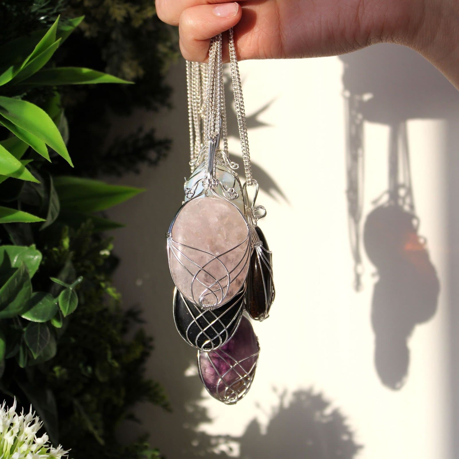 Black onyx pendant in a silver swirl frame on a chain