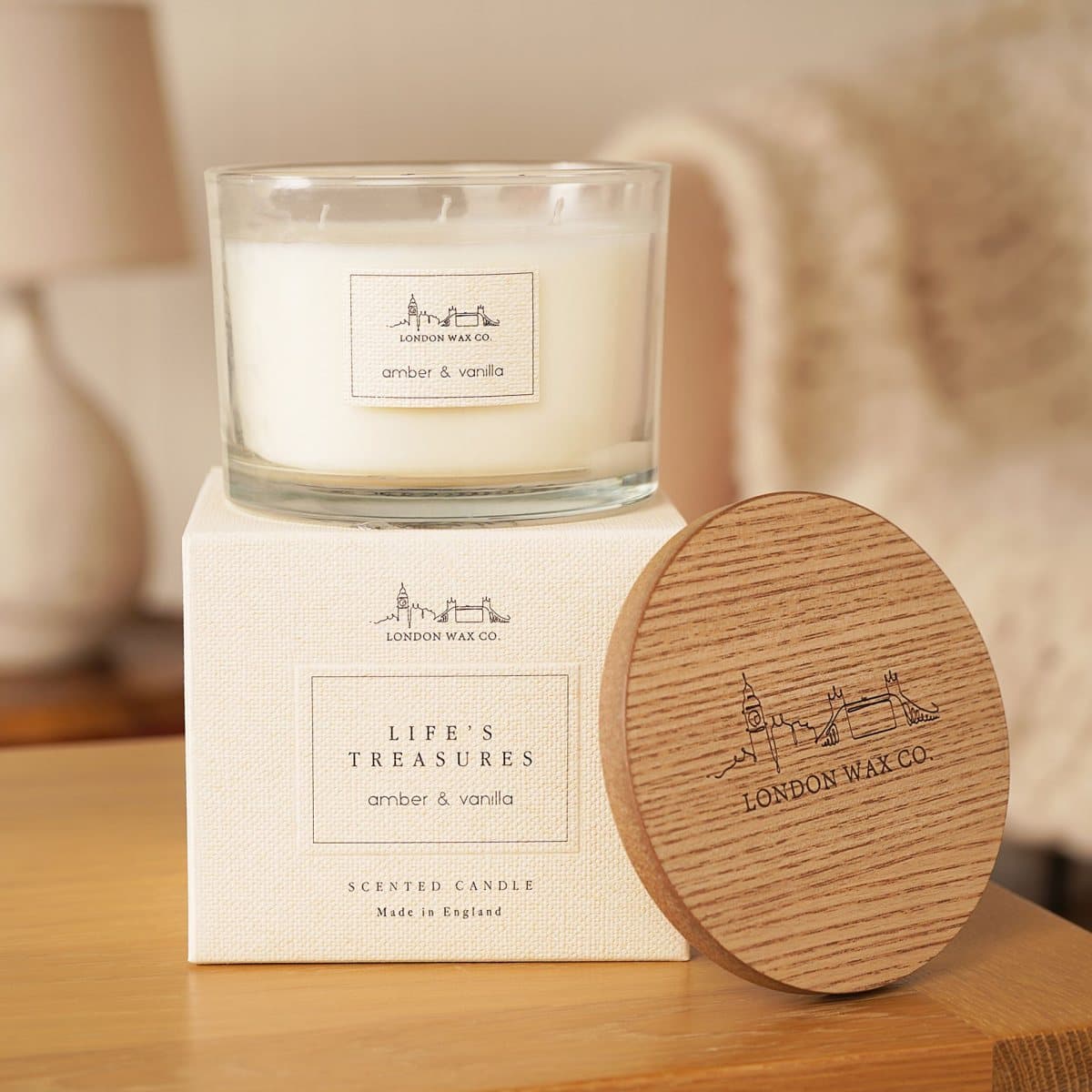 Amber and vanilla candle in a glass jar with a wooden lid