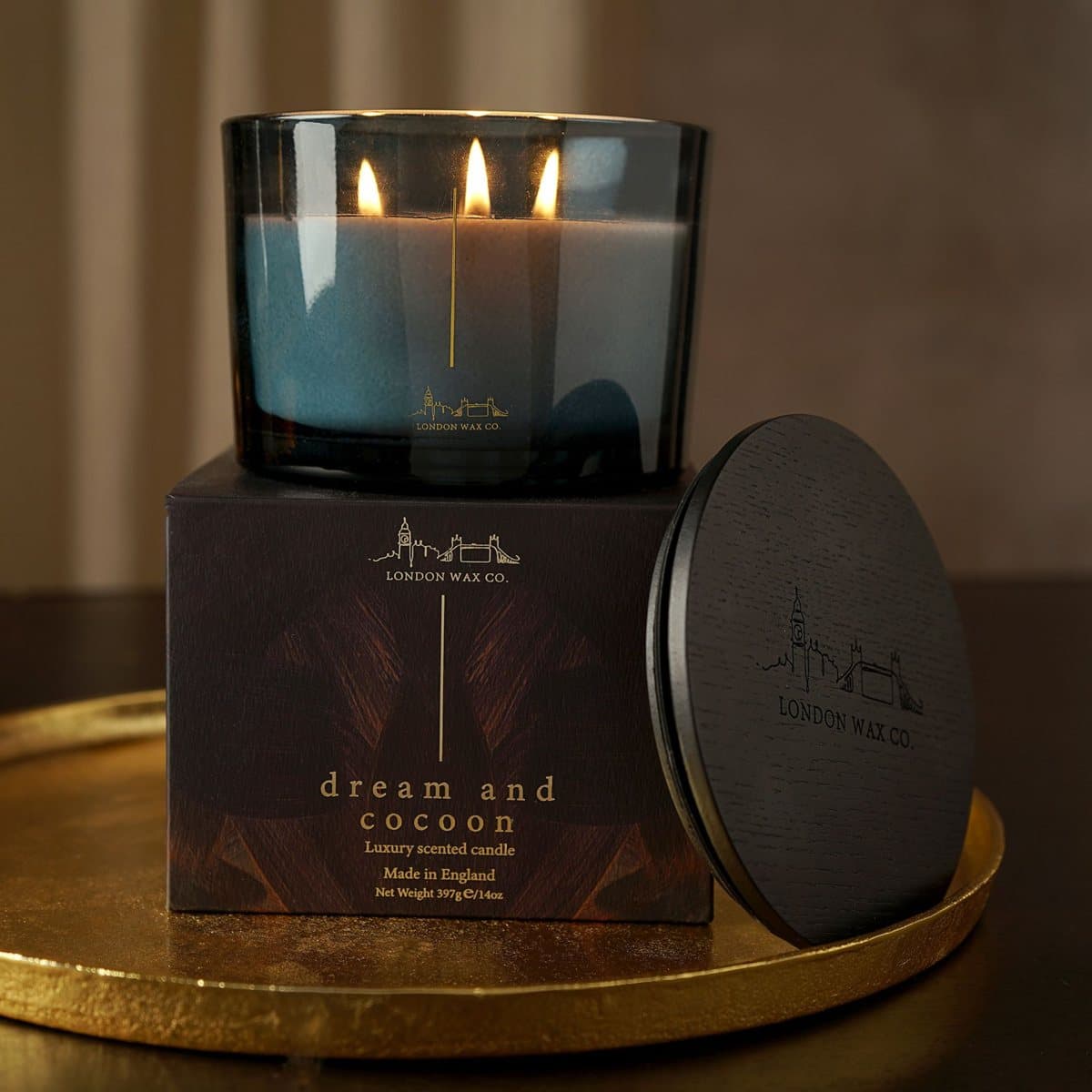 Deep green glass jar 3 wick candle with a black lid and black box