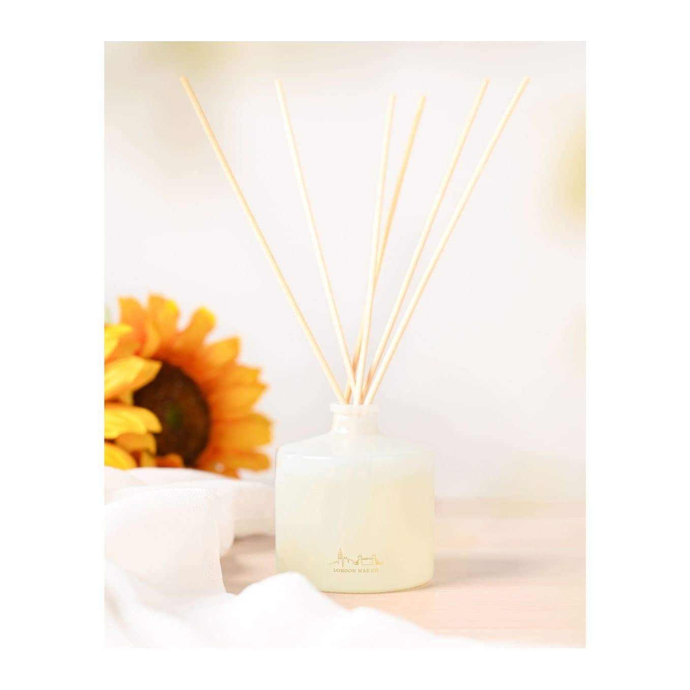 Floral Fields reed diffuser glass bottle with wooden reeds and white floral box