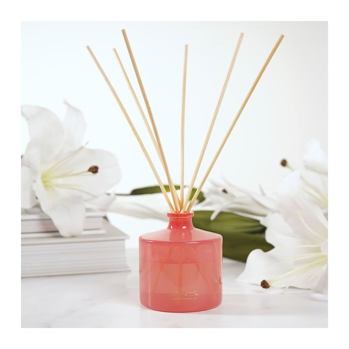 Paradise Found diffuser in a red glass bottle with red floral box