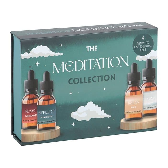 Four glass essential oil bottles with dropper lids in a cardboard display box